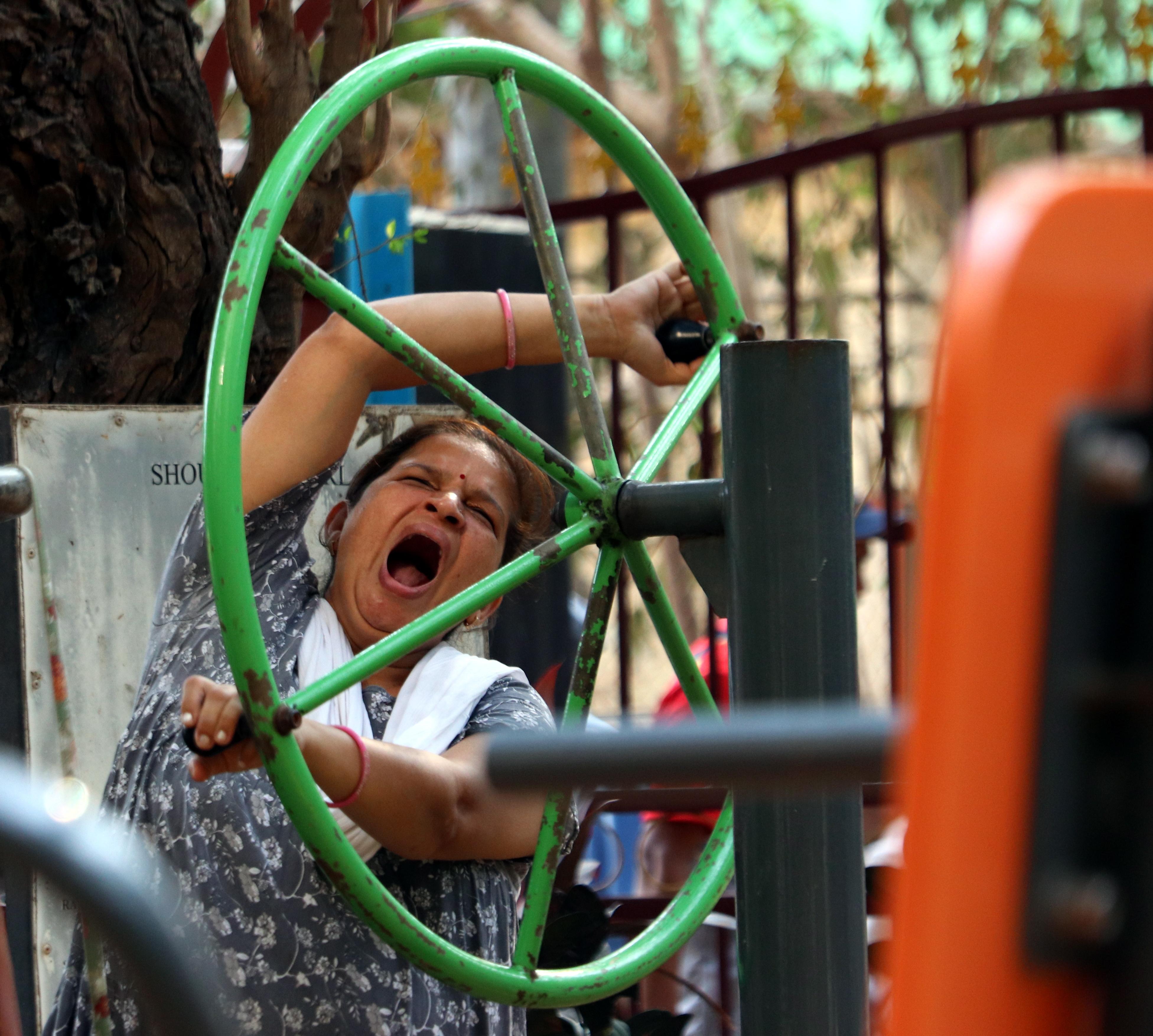 A woman is seen yawning as she works out during evening hours in a park at Juhu, Mumbai
Pic/Anurag Ahire